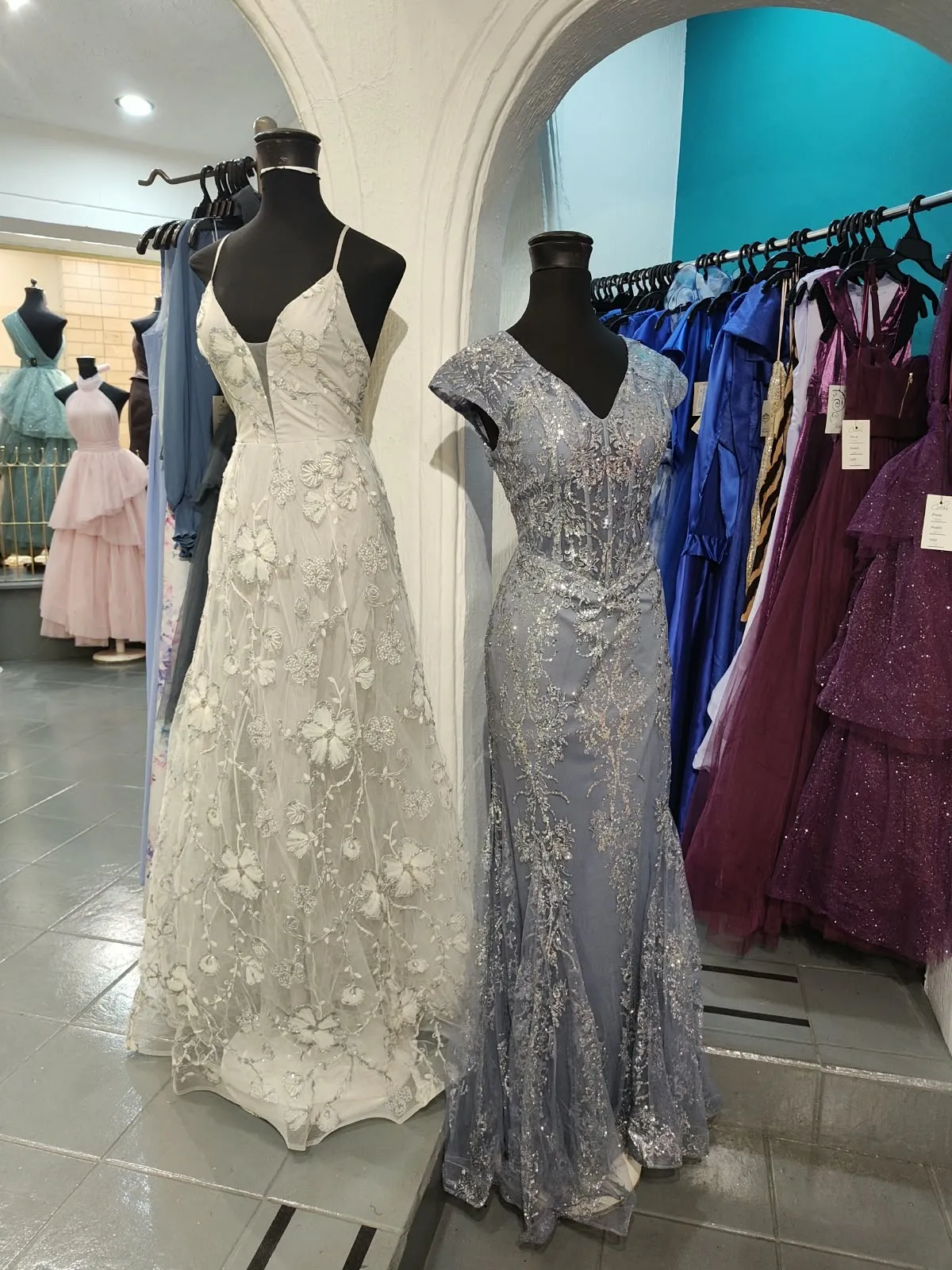 Vestido largo marfil de encaje y vestido plateado de brillo corte sirena